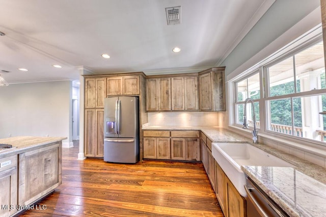 kitchen with sink, crown molding, decorative backsplash, light hardwood / wood-style floors, and stainless steel appliances