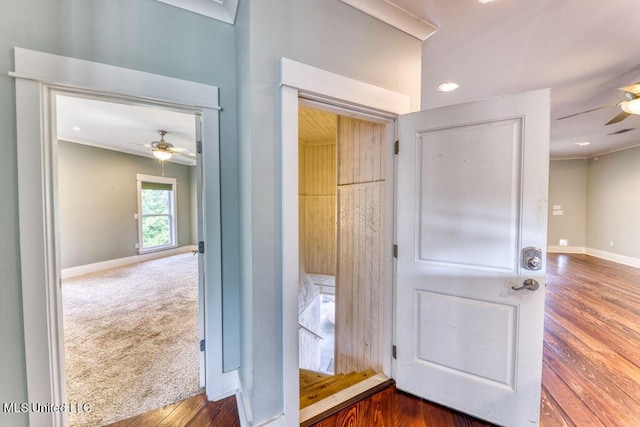 interior space with ornamental molding and dark colored carpet