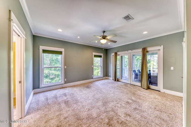 spare room featuring ceiling fan, light colored carpet, crown molding, and french doors