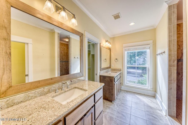 bathroom with crown molding, tile patterned flooring, vanity, and walk in shower