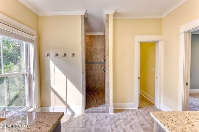 bathroom featuring tiled shower and ornamental molding