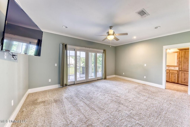 spare room featuring light carpet, french doors, ceiling fan, and ornamental molding