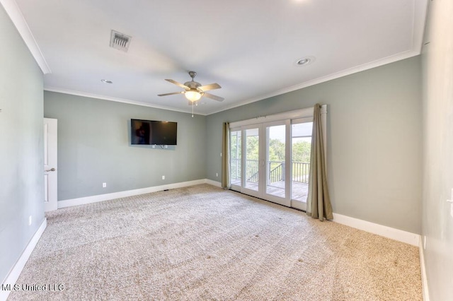 spare room featuring light carpet, crown molding, ceiling fan, and french doors