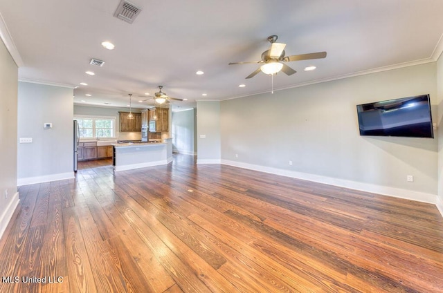 unfurnished living room with ceiling fan, wood-type flooring, and ornamental molding