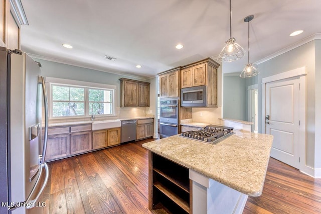 kitchen with backsplash, hanging light fixtures, sink, ornamental molding, and appliances with stainless steel finishes