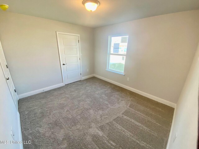 unfurnished bedroom with carpet floors and a closet