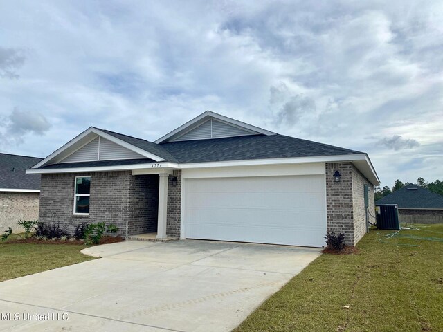 single story home featuring a front yard, a garage, and central AC unit