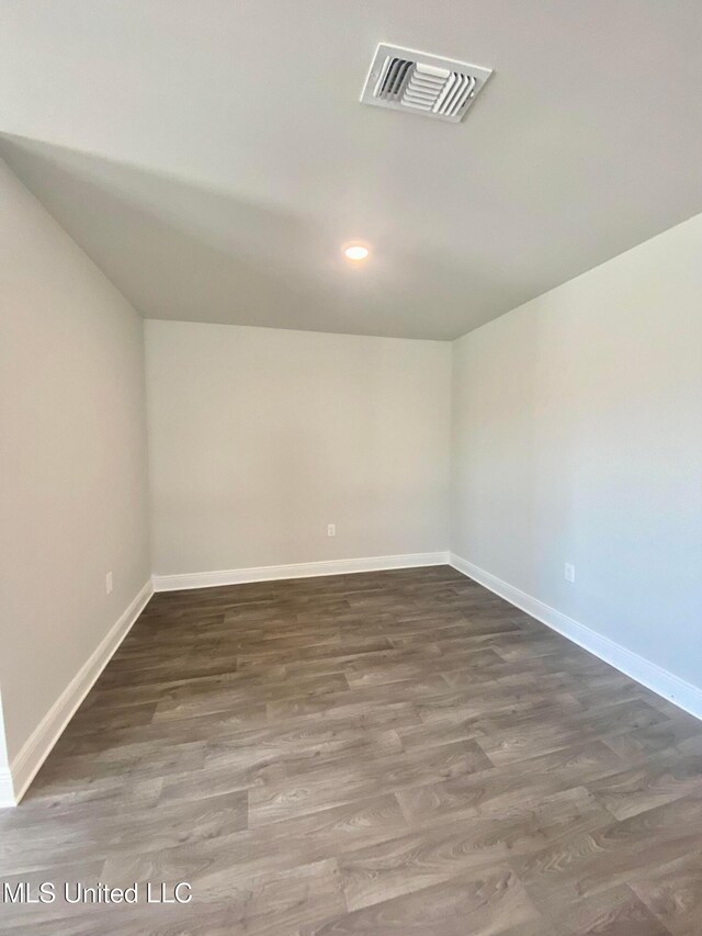 spare room featuring dark hardwood / wood-style floors