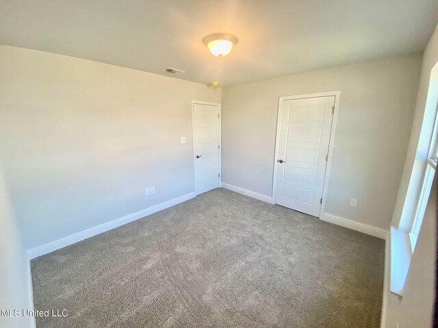 unfurnished bedroom featuring a closet and carpet floors