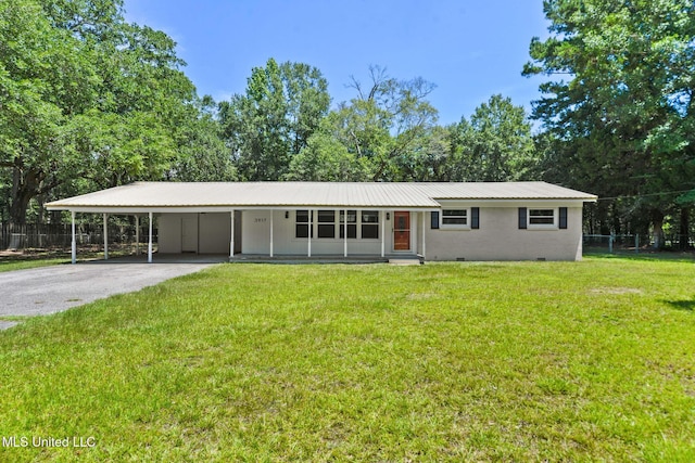 3917 Wildwood Rd, Moss Point, MS 39562 - view of front facade featuring crawl space, asphalt driveway, a metal roof, and an attached carport