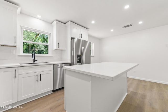 3917 Wildwood Rd, Moss Point, MS 39562 - kitchen featuring stainless steel appliances, light wood-style flooring, light countertops, white cabinets, and recessed lighting