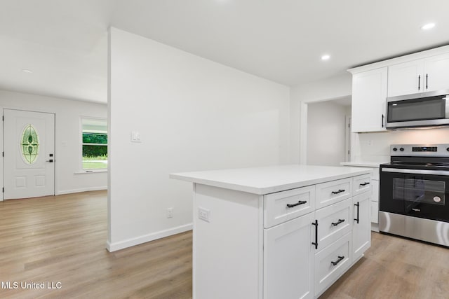 3917 Wildwood Rd, Moss Point, MS 39562 - kitchen featuring stainless steel appliances, light wood-style flooring, light countertops, a kitchen island, and recessed lighting