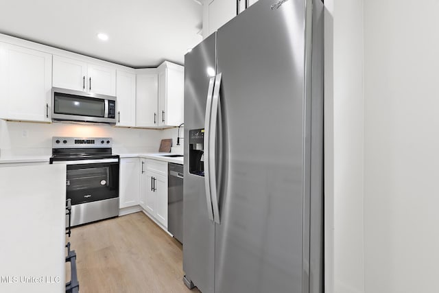 3917 Wildwood Rd, Moss Point, MS 39562 - kitchen featuring appliances with stainless steel finishes, light countertops, white cabinetry, and recessed lighting