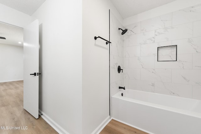 3917 Wildwood Rd, Moss Point, MS 39562 - bathroom with wood finished floors, shower / bathtub combination, and a textured ceiling
