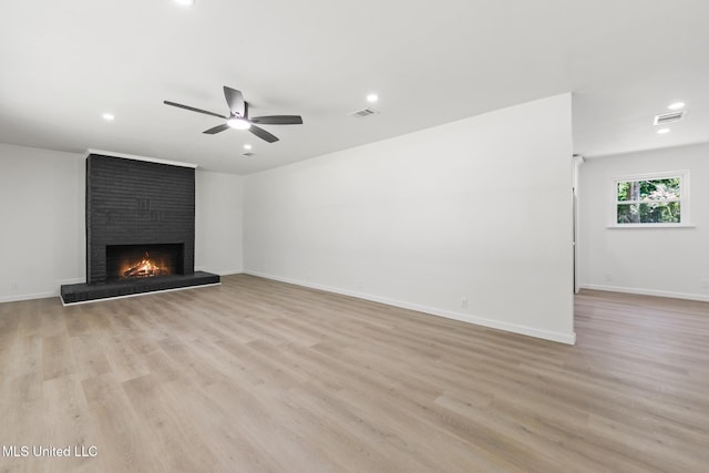 3917 Wildwood Rd, Moss Point, MS 39562 - unfurnished living room with a brick fireplace, recessed lighting, ceiling fan, and light wood-style flooring