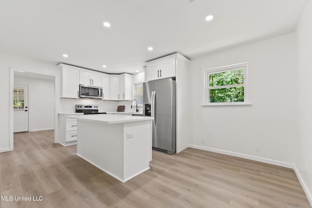 3917 Wildwood Rd, Moss Point, MS 39562 - kitchen featuring appliances with stainless steel finishes, a center island, white cabinetry, light countertops, and recessed lighting