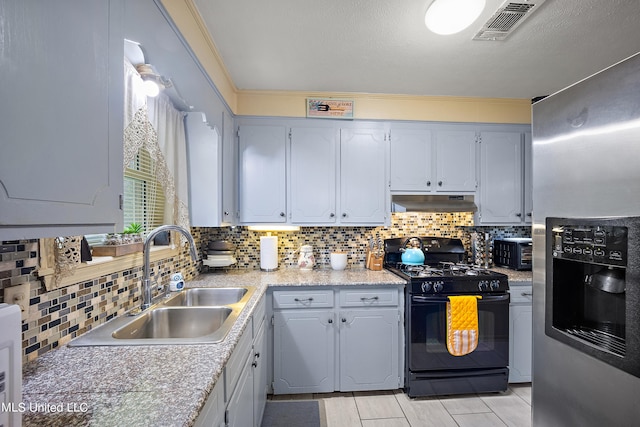 kitchen with sink, gas stove, crown molding, decorative backsplash, and stainless steel fridge with ice dispenser