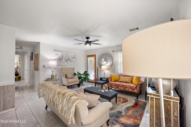 living room featuring light tile patterned flooring and ceiling fan