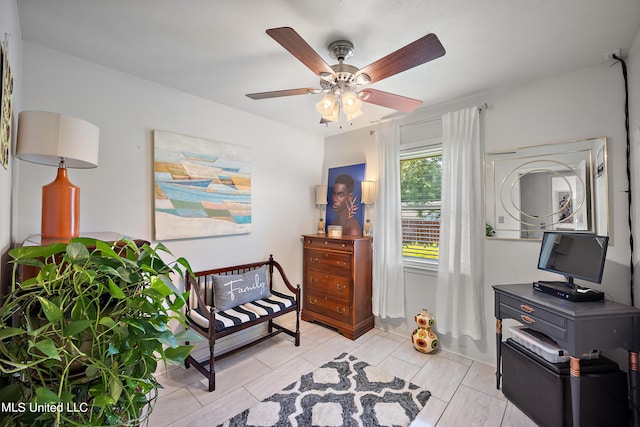 living area featuring light tile patterned floors and ceiling fan