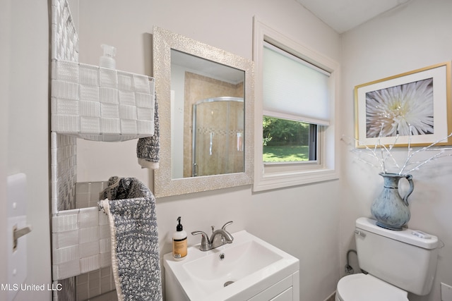 bathroom featuring toilet, walk in shower, and sink