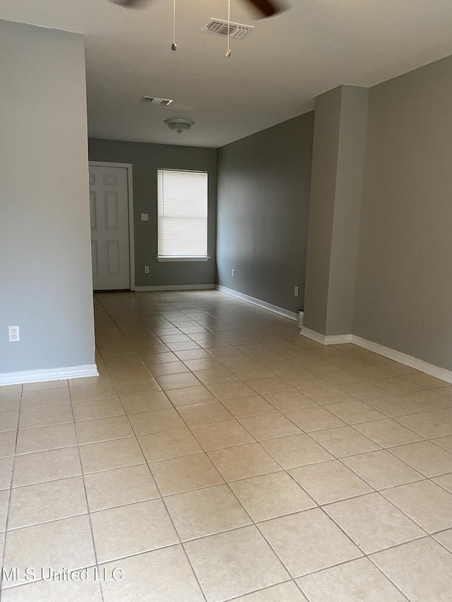 unfurnished room featuring ceiling fan and light tile patterned floors