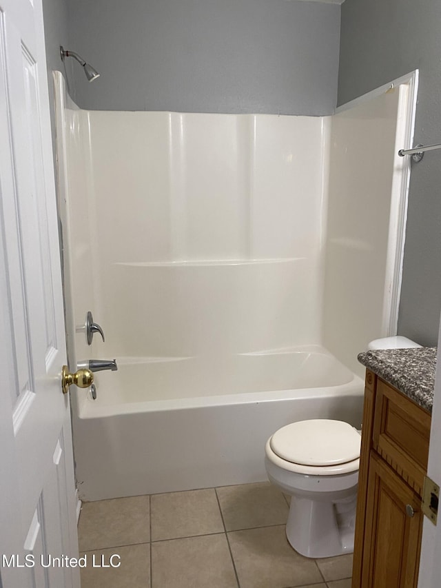 full bathroom with toilet, tile patterned flooring, washtub / shower combination, and vanity