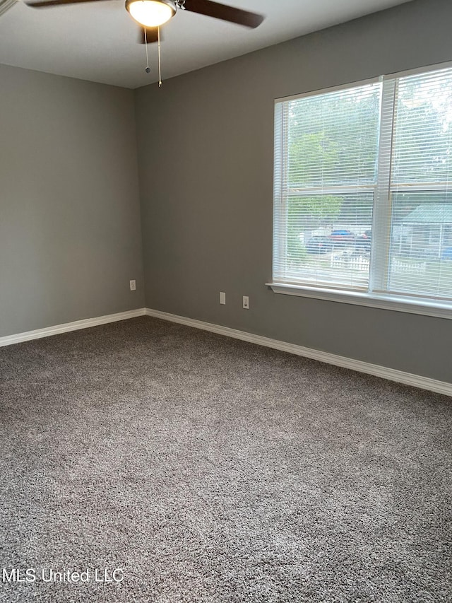 empty room featuring ceiling fan, a healthy amount of sunlight, and carpet floors