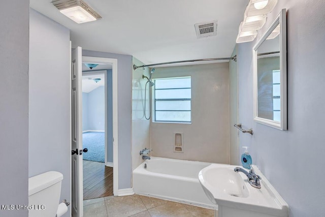 bathroom featuring shower / tub combination, tile patterned floors, and toilet