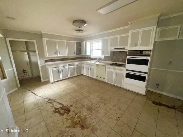 kitchen featuring white cabinets, decorative backsplash, sink, and white appliances