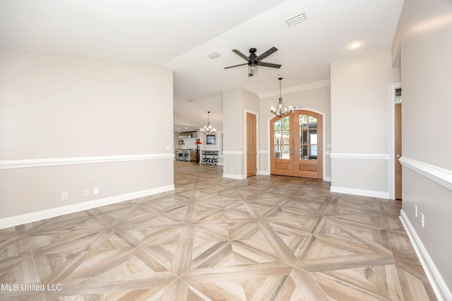 empty room featuring baseboards, ceiling fan with notable chandelier, lofted ceiling, and visible vents