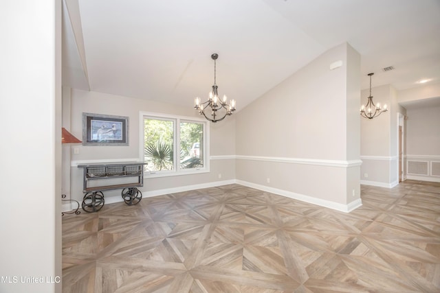 unfurnished room with visible vents, baseboards, a chandelier, and vaulted ceiling