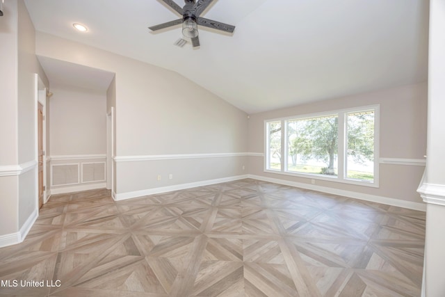 spare room featuring visible vents, a ceiling fan, baseboards, and lofted ceiling