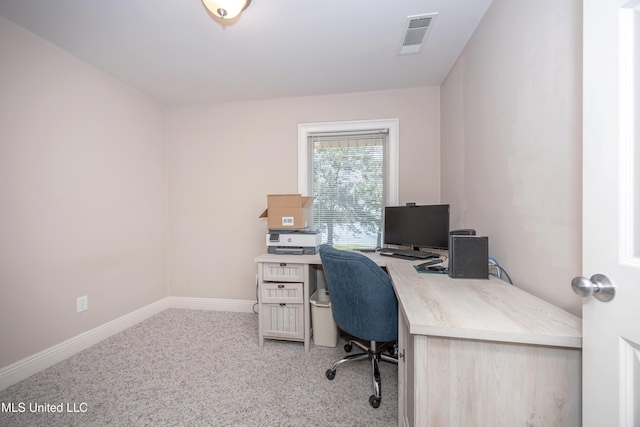 office featuring baseboards, visible vents, and light carpet