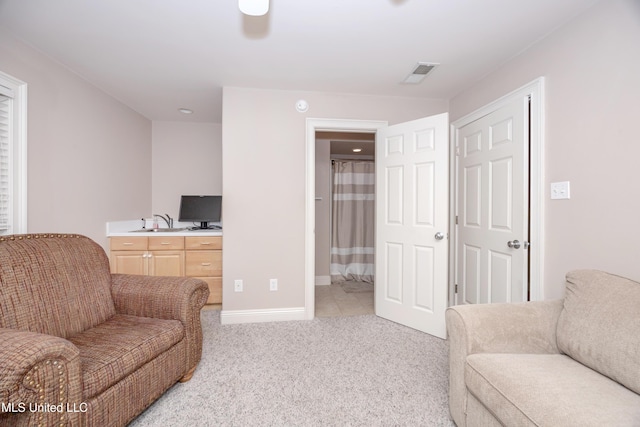 living room with baseboards, light carpet, and visible vents