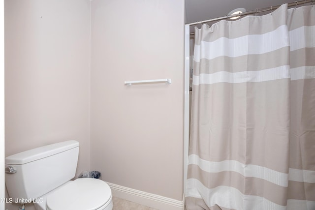 full bathroom featuring toilet, baseboards, curtained shower, and tile patterned flooring