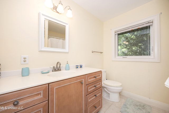 full bath featuring vanity, tile patterned floors, and toilet