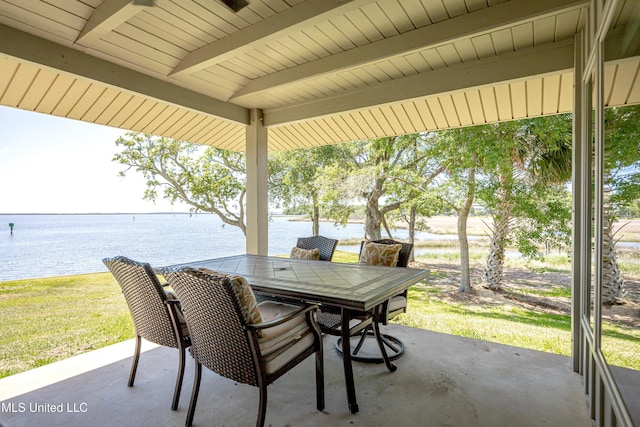 view of patio / terrace featuring outdoor dining area and a water view