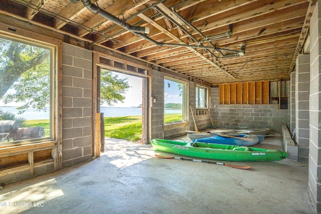 miscellaneous room with a healthy amount of sunlight and a water view