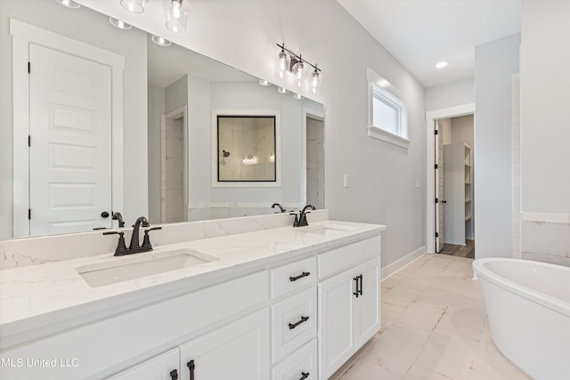 bathroom with vanity and a bath