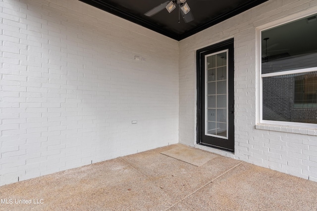 property entrance with a patio and ceiling fan