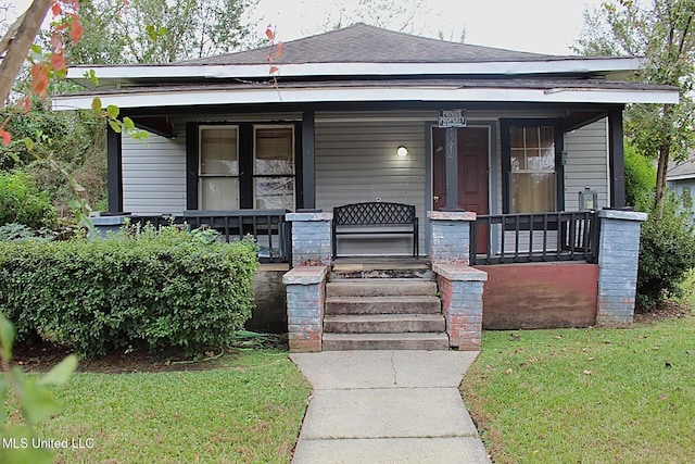 bungalow-style house with a front lawn and covered porch