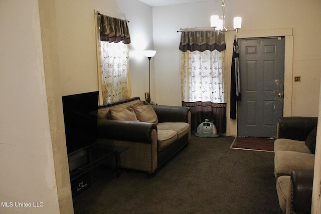 living room featuring a notable chandelier and dark carpet