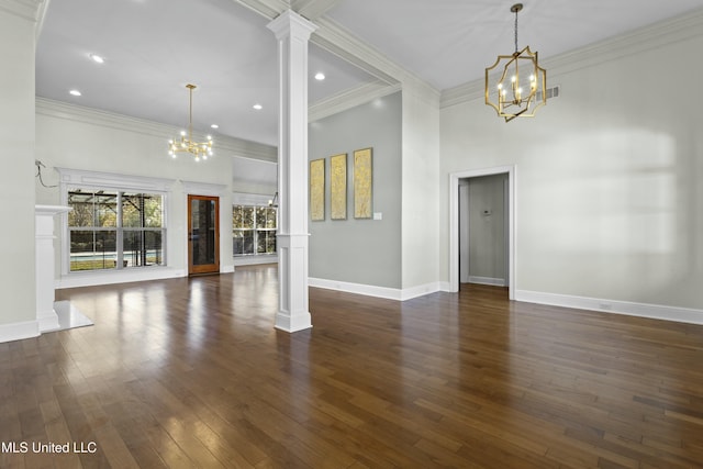 unfurnished living room with ornate columns, a high ceiling, dark hardwood / wood-style flooring, a chandelier, and crown molding