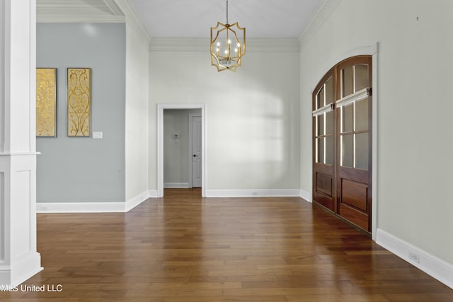 interior space featuring dark hardwood / wood-style flooring, an inviting chandelier, and ornamental molding