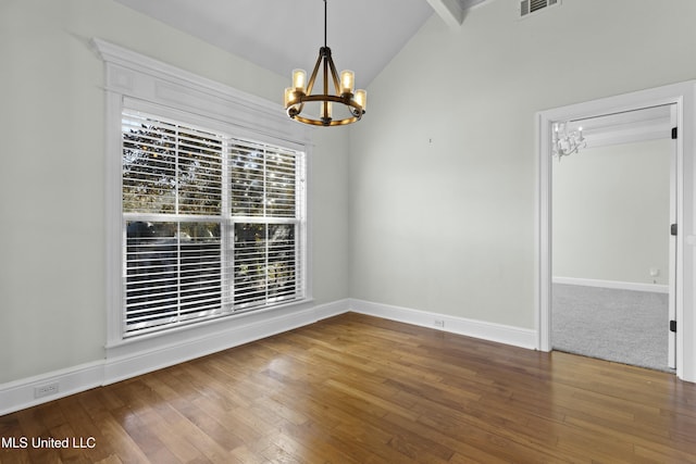 spare room with hardwood / wood-style floors, lofted ceiling with beams, and a notable chandelier