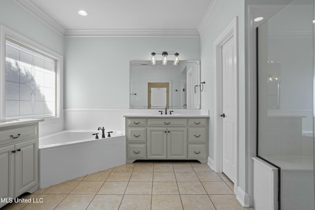 bathroom featuring a bathing tub, tile patterned flooring, crown molding, and vanity