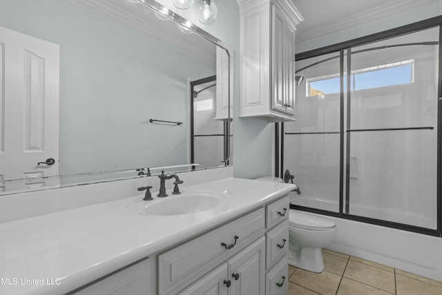 full bathroom featuring toilet, bath / shower combo with glass door, tile patterned floors, crown molding, and vanity