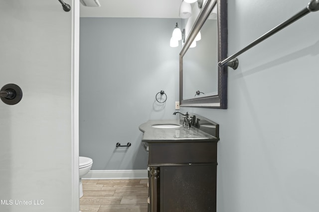 bathroom featuring toilet and vanity