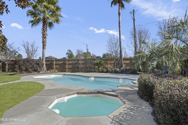 view of swimming pool with an in ground hot tub