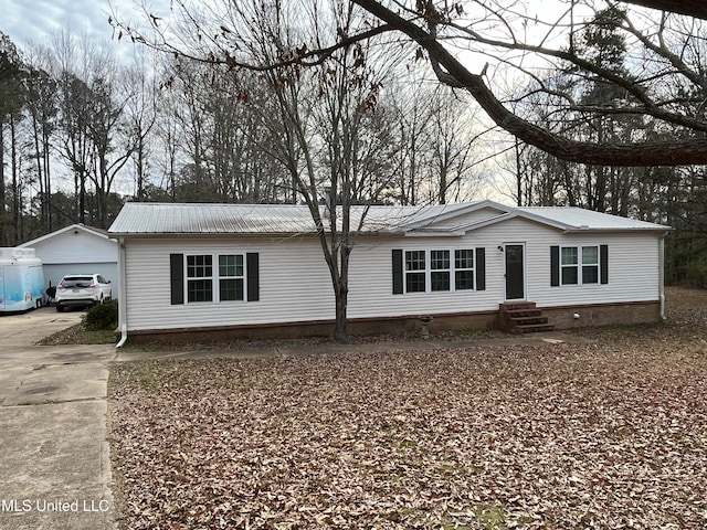 view of front facade with a garage and an outbuilding